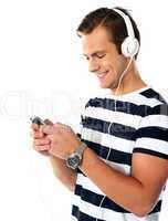 Male teenager with mp3 player and earbuds