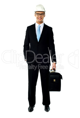 Portrait of smiling young architect carrying briefcase