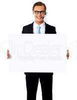 Smiling male operator with blank billboard