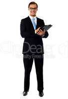 Full length view of relaxed businessman holding a folder