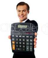 Modern businessman showing calculator