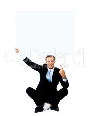 Business professional pointing up towards blank placard