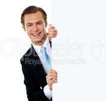 Smiling business professional behind blank clipboard