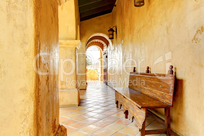 Spanish building details with arches and bench.