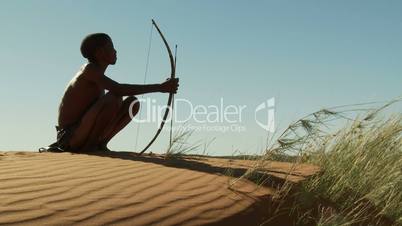 Hunting Kalahari Bushman sitting on dune