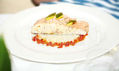 Plate with baked salmon and rice with vegetables