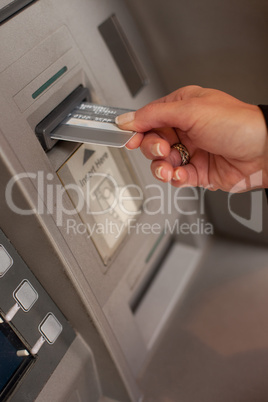 Female hand inserting ATM card