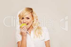 Blonde woman biting an apple