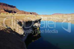 Coloured rocky shore of Colorado River near Hite, Utah