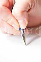 womans hand is writing a letter with a pen