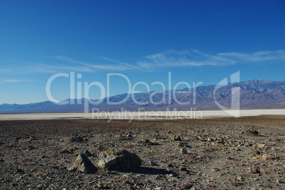 Dispersed rocks, salt flats and high Panamint Range mountains, Death Valley, California