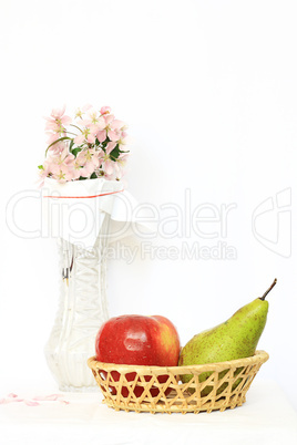 basket with fruits and vase with flower