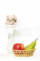 basket with fruits and vase with flower