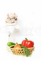 vase with flower and basket with vegetables