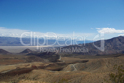 Rocks with view of valley and high mountains near Death Valley, California