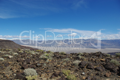 Rocks with view of valley and high mountains near Death Valley, California