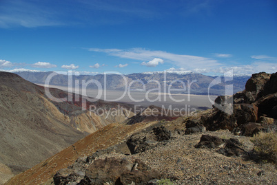Black rocks, valleys and snow mountains near Death Valley, California