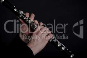Clarinet player in front of black background