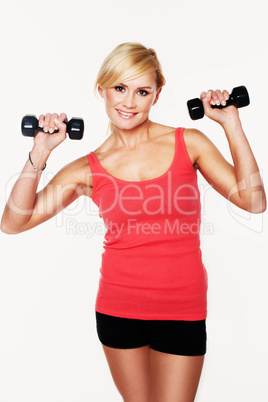 Fit woman lifting dumbbells