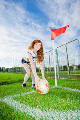 Beautiful redhead girl plays soccer