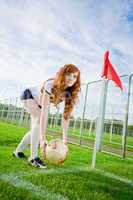 Beautiful redhead girl plays soccer