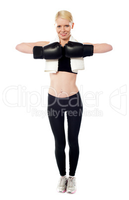 Happy female boxer posing with gloves on