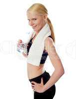 Fit female athlete holding a bottle of water