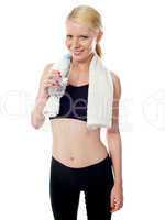 Young pretty woman in sport wear drinking water