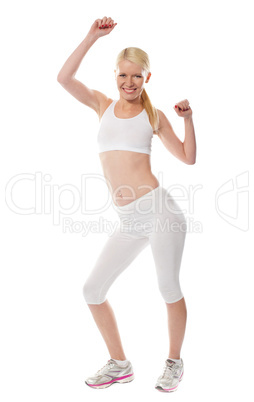 Cheerful sporty fit girl in sporty outfit