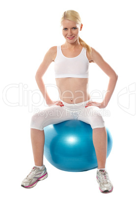 Gorgeous teenager sitting on exercise ball