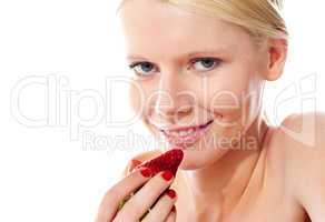 Closeup of young gorgeous girl holding strawberry