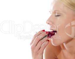 Young beautiful caucasian lady tasting yummy strawberry