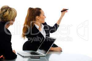 two women during a business meeting with laptop on white backgro