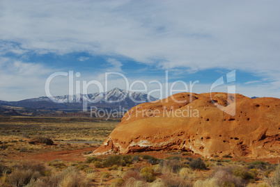 Red rock hill, highway, desert and Henry Mountains, Utah