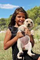 puppy labrador and smiling girl
