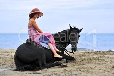 woman and  horse on the beach