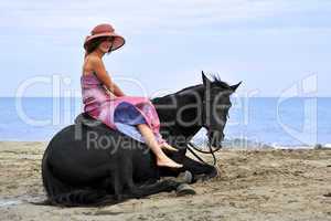 woman and  horse on the beach