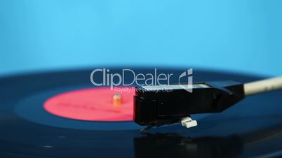 Needle moves across vinyl on turntable