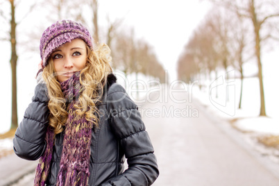 young woman outside in winter in snow cold