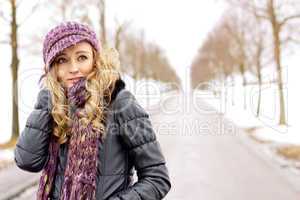 young woman outside in winter in snow cold