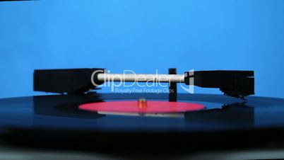 Needle moves across vinyl on turntable