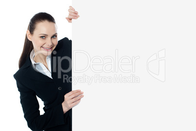 Female executive holding blank whiteboard