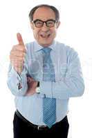 Matured businessman gesturing thumbs-up