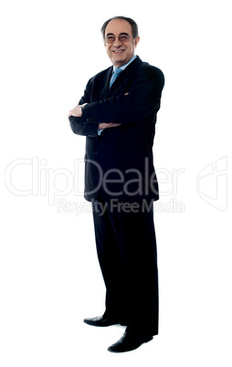 Smiling senior executive posing with folded arms