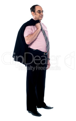Senior executive holding his coat over shoulders