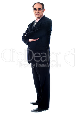 Aged company manager posing with folded arms