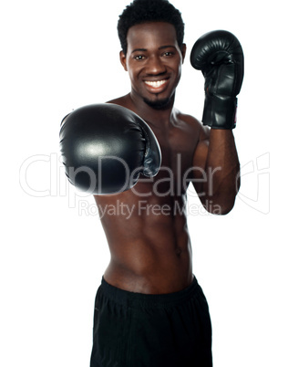 Shirtless african boxer ready to punch you