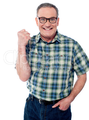 Excited elderly male dressed in casuals