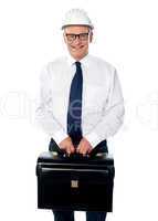 Handsome senior builder holding briefcase