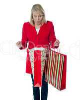 Lady surprised to see empty shopping bag